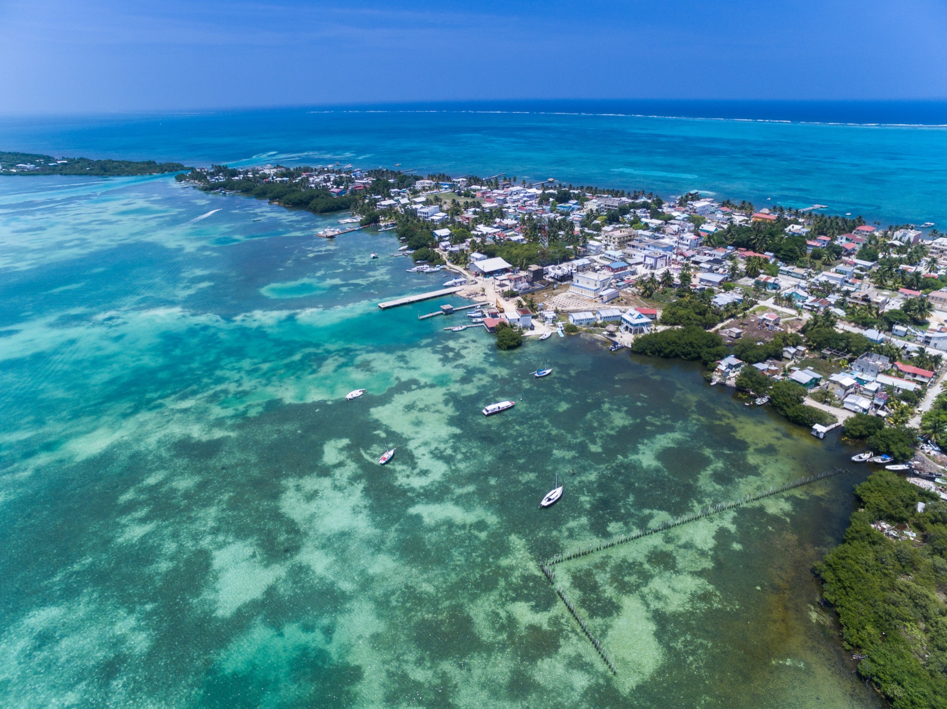 Aerial view of turquoise Caribbean water and the island of Caye Caulker, Belize